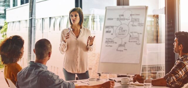 woman presenting to colleagues