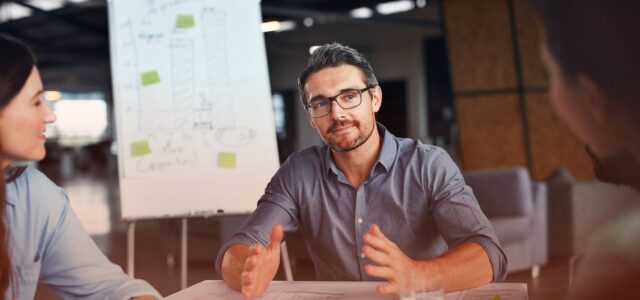 confident man sharing insights in office