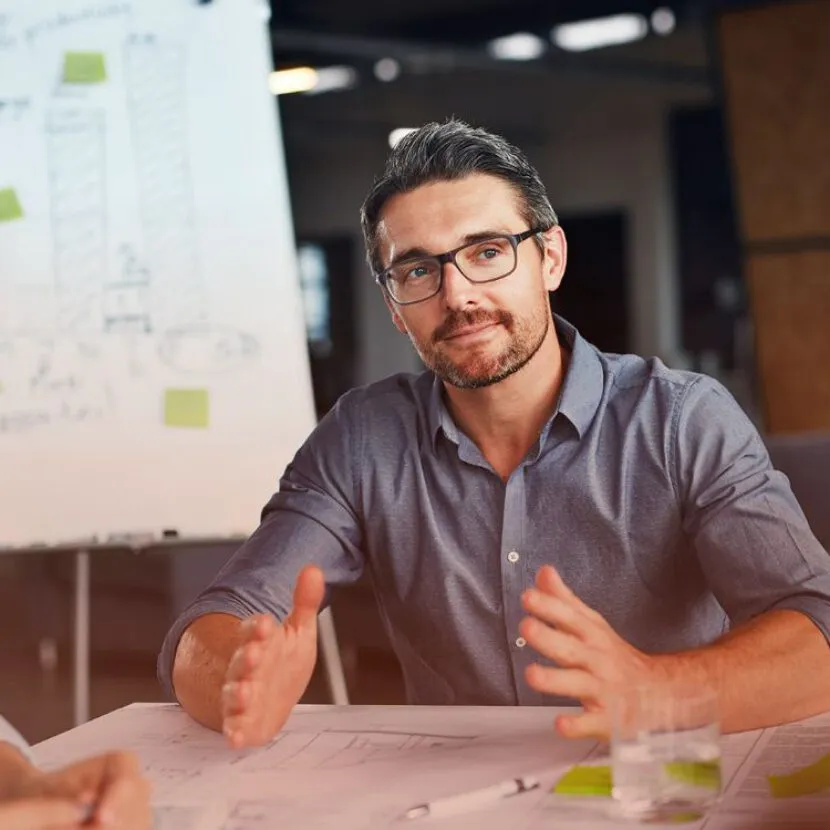 confident man sharing insights in office
