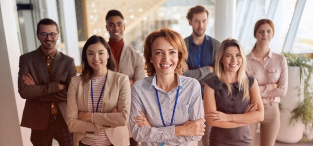 smiling group photo with arms crossed
