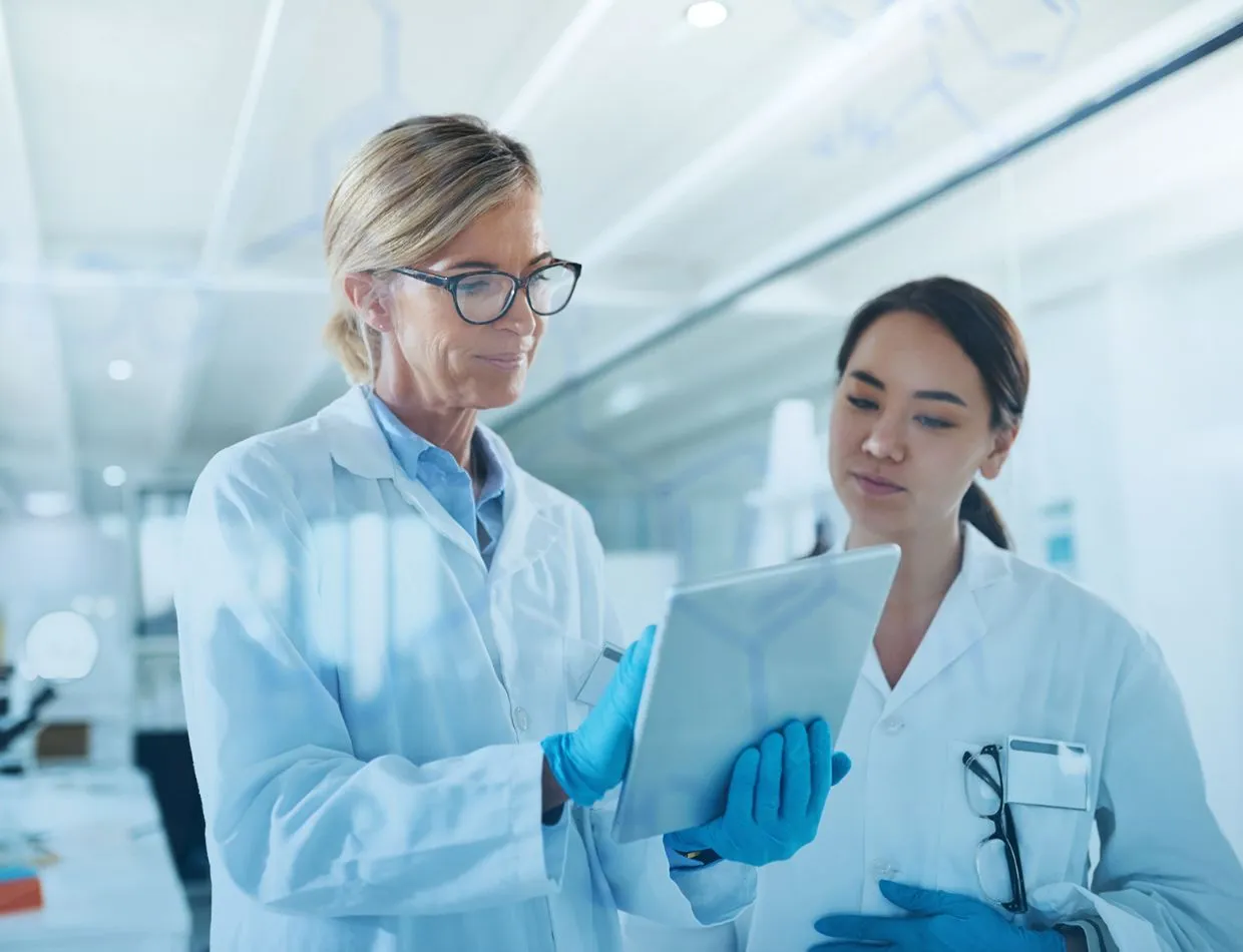 two medical clinicians accessing tablet