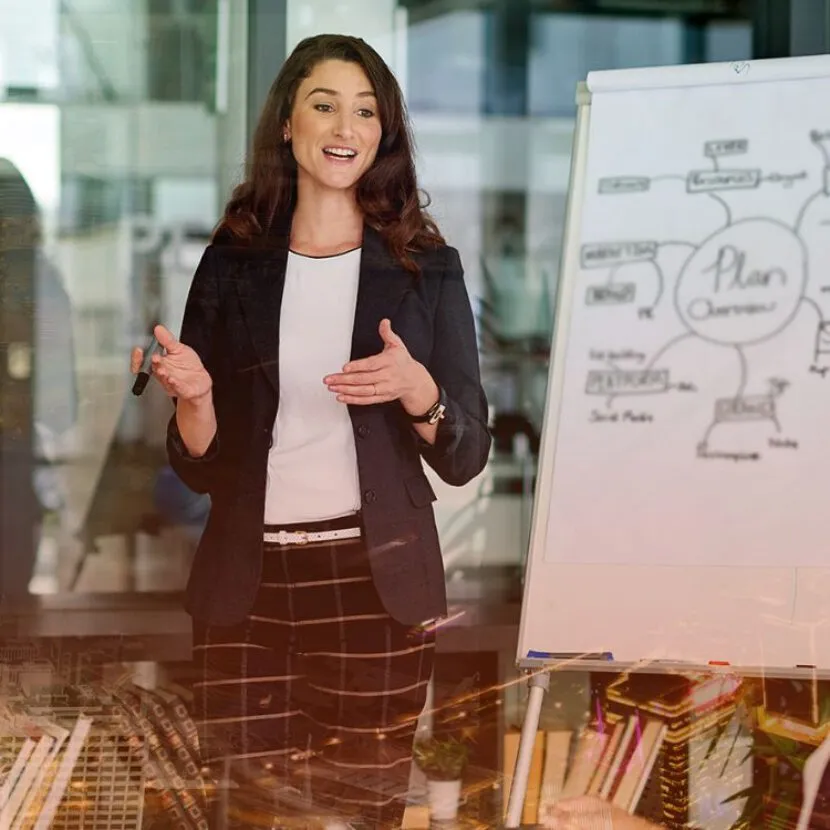 confident woman talking charts with team