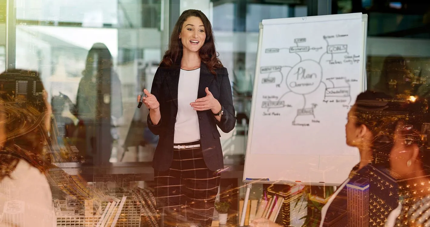 confident woman talking charts with team