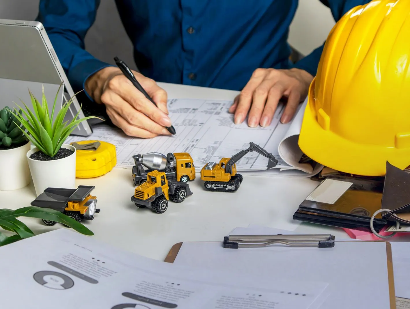 jotting notes with pen on report