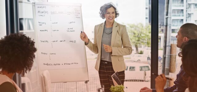 smiling woman charting on board