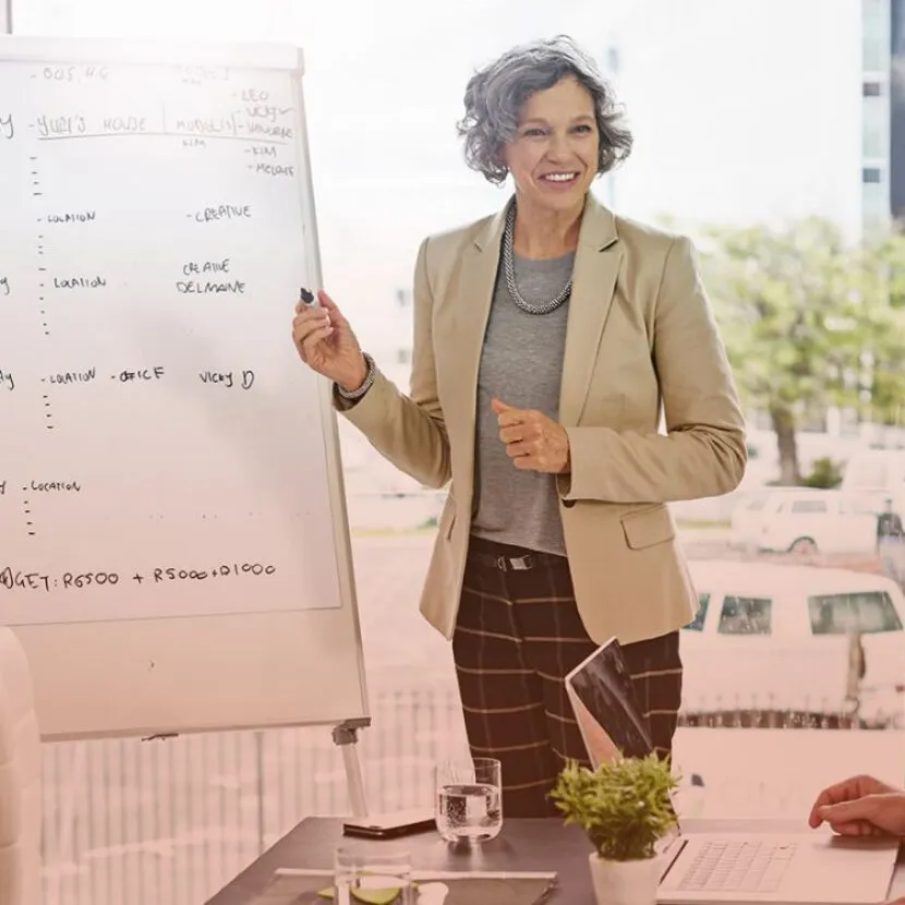 smiling woman charting on board