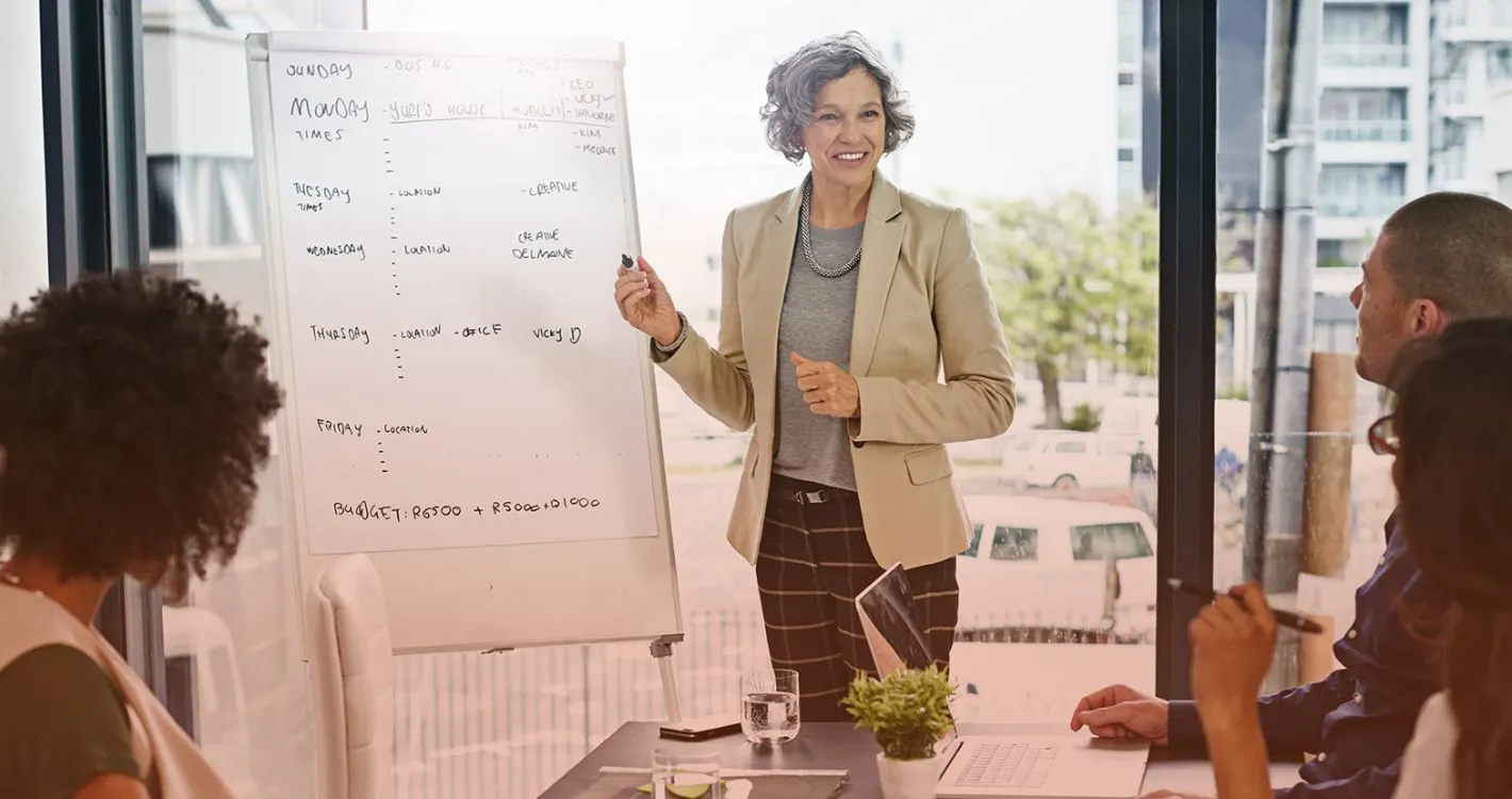 smiling woman charting on board