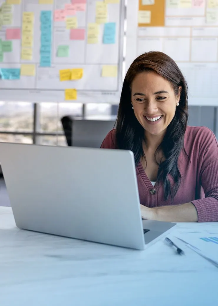 smiling woman working on laptop