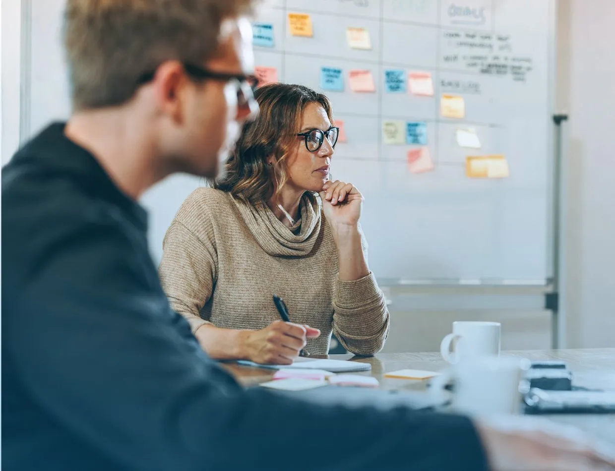 pondering woman in meeting room