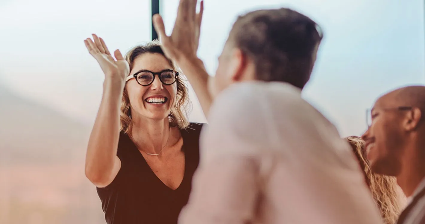 staff high-fiving each other